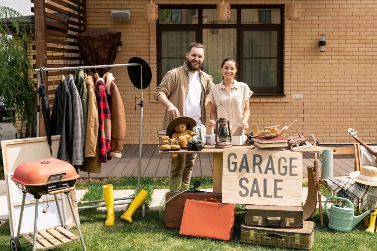 Cheerful couple hosting garage sale